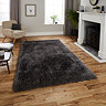 image of dark grey shaggy rug on light wooden floor in modern apartment