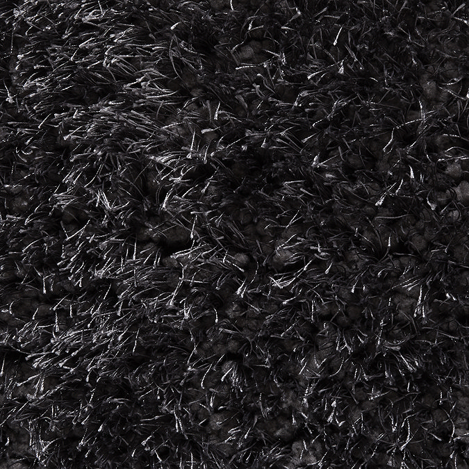 close up on material and colour of dark grey shaggy rug