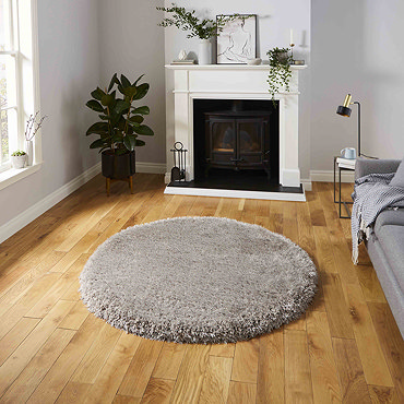 angled image of grey shaggy rug on light wooden flooring