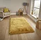 angled image of yellow shaggy rug on light wooden flooring