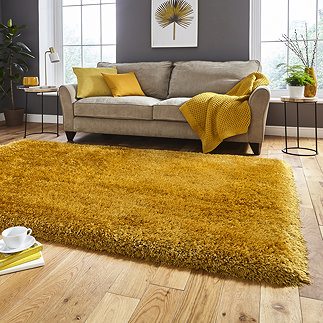 image of mustard yellow shaggy rug in front of beige sofa with yellow accent cushions