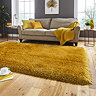 image of mustard yellow shaggy rug in front of beige sofa with yellow accent cushions