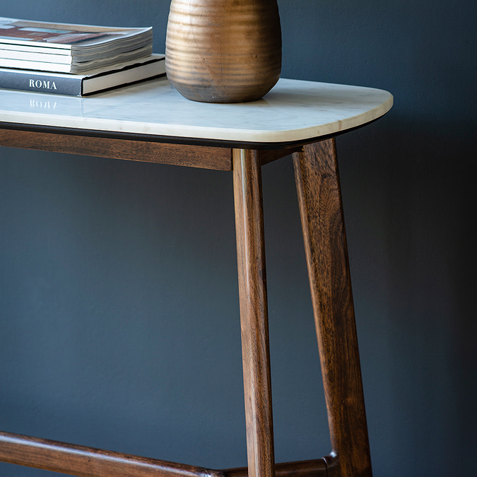 close up image of rounded edge of marble top of console table