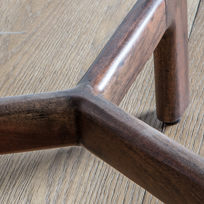 close up image of dark acacia wood base of side table
