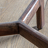 close up image of dark acacia wood base of side table