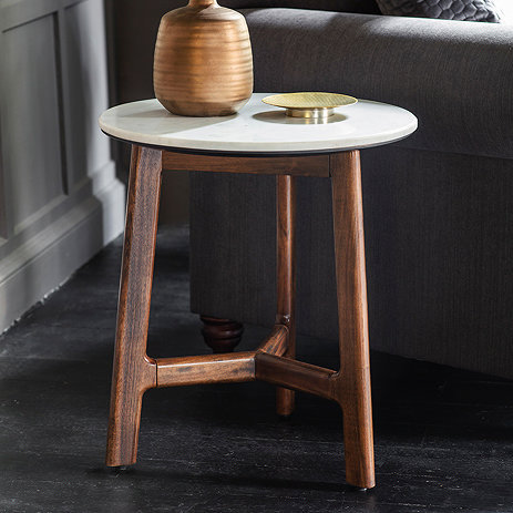 image of round marble top dark wood coffee table next to sofa