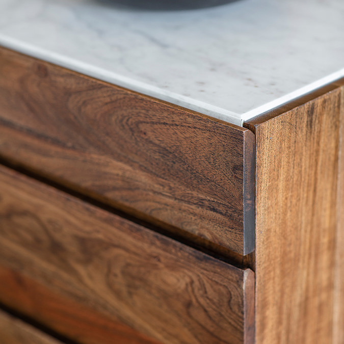 close up image of dark wood of sideboard drawers with marbletop