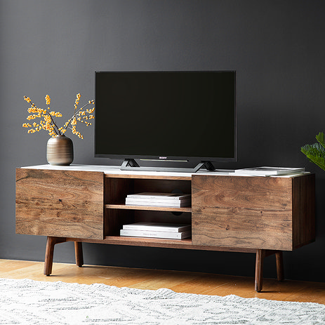 image of dark wood marble top tv unit against grey wall with tv atop it