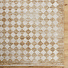 close up image of mustard and cream diamond patterned rug