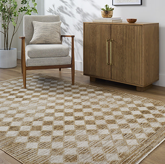 image of mustard and cream diamond pattern rug on light wooden flooring next to fluted sideboard