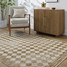 image of mustard and cream diamond pattern rug on light wooden flooring next to fluted sideboard