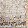 close up image of corner of rustic rug in brown shades