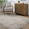 image of rustic rug in shades of brown on a light wooden floor