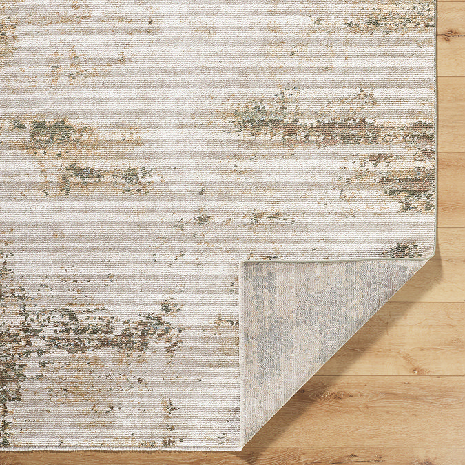 image of rustic area rug in olive green and brown shades folded over at corner to show material underneath