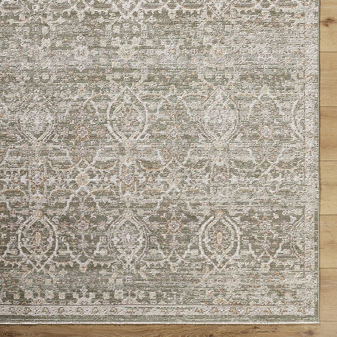 close up image of corner of olive green boho patterned rug olive and brown
