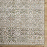 close up image of corner of olive green boho patterned rug olive and brown