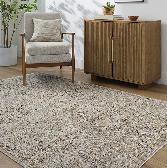 image of brown and taupe floral boho rug on light wood flooring