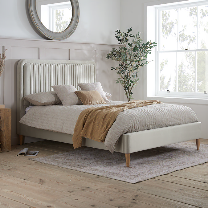 image of bed with wooden feet and vertical channel detailing on the stone coloured headboard, featuring wooden feet