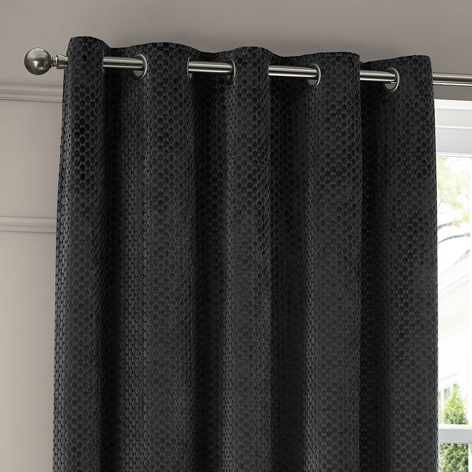 Neptune Charcoal Eyelet Curtains over a window close up image