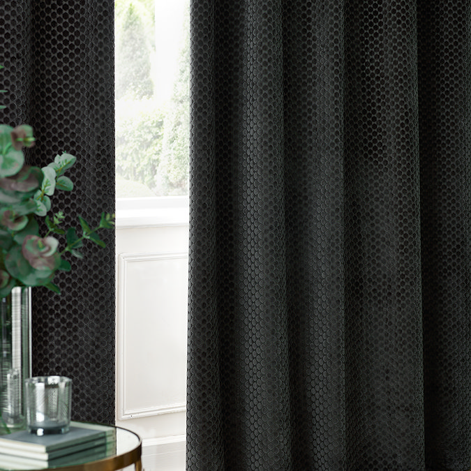 Neptune Charcoal Eyelet Curtains over a window close up image
