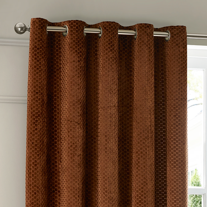 Neptune Eyelet Curtains in Copper over a window close up image