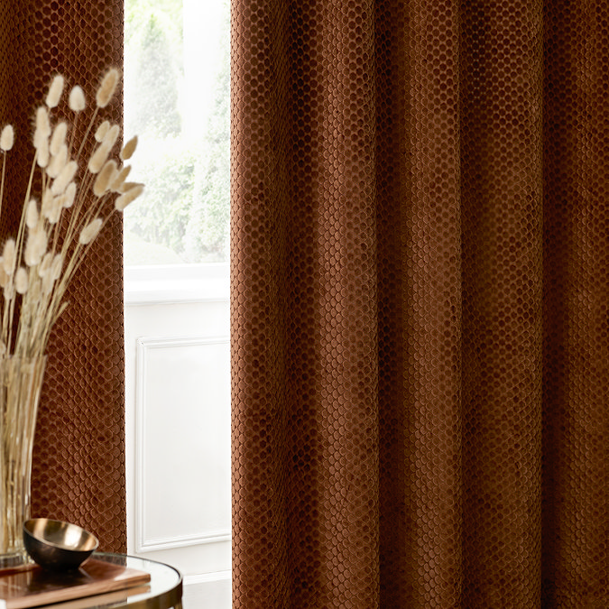 Neptune Eyelet Curtains in Copper over a window close up image