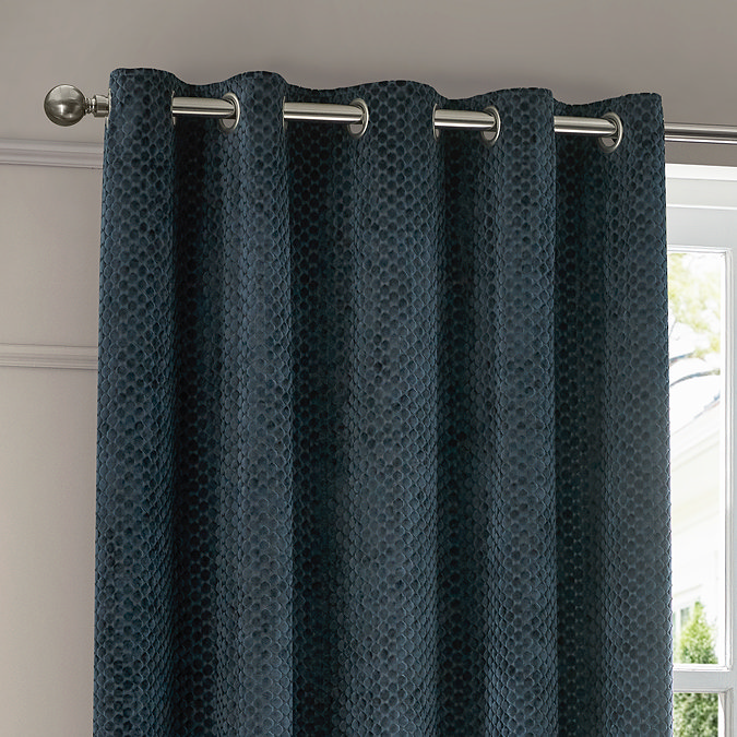 Neptune Eyelet Curtains in Navy over a window close up image