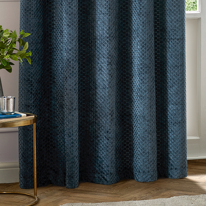 Neptune Eyelet Curtains in Navy over a window close up image