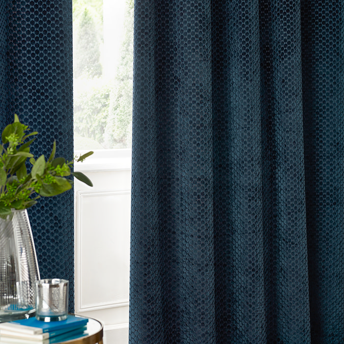Neptune Eyelet Curtains in Navy over a window close up image