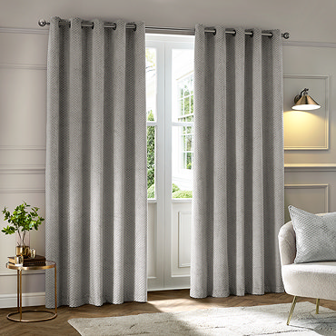 Neptune Eyelet Curtains in Silver over a window close up image