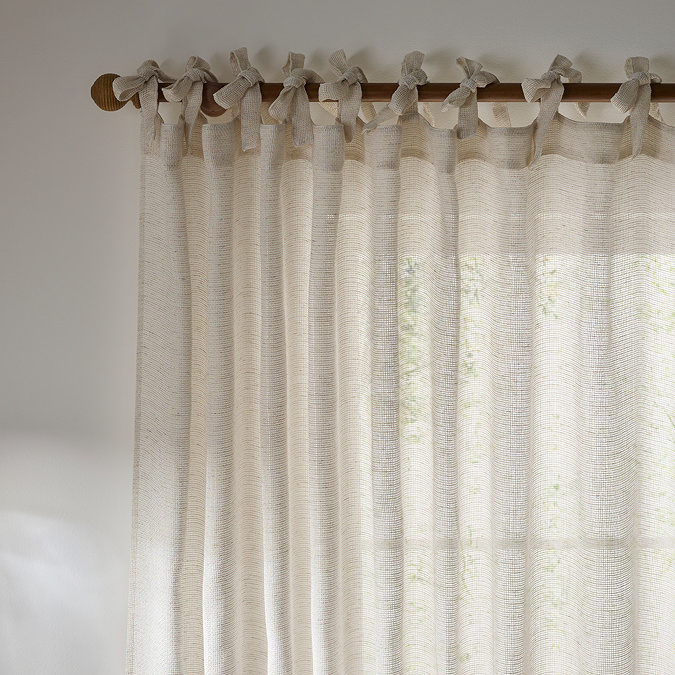 Nimbus Tie Top Sheer Curtain Panel in natural in front of a window close up image