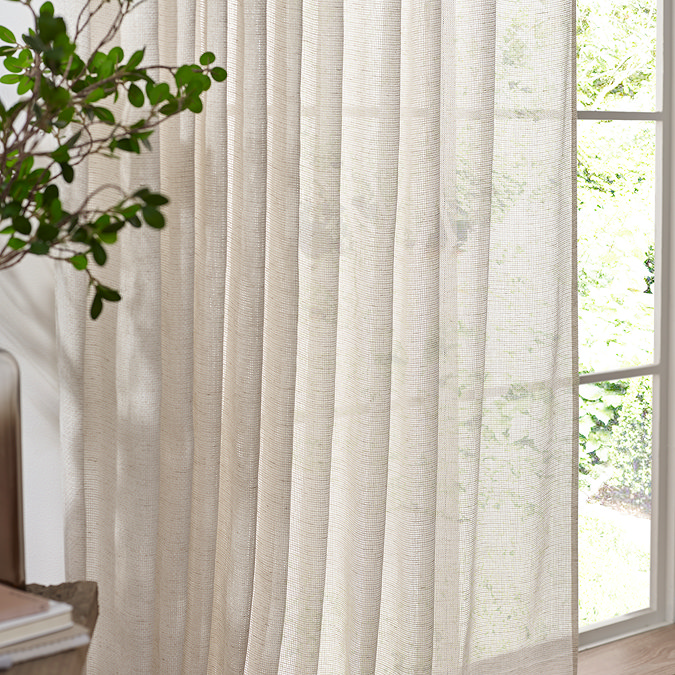 Nimbus Tie Top Sheer Curtain Panel in natural in front of a window close up image