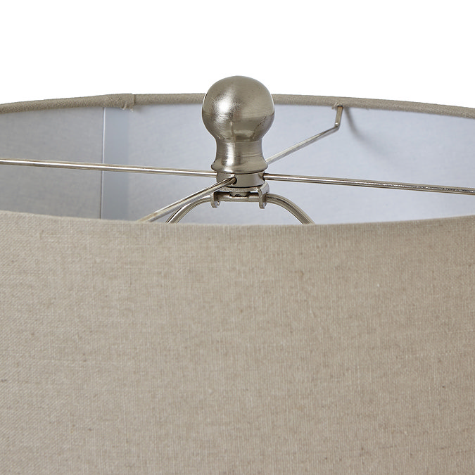 close up image of top of lamp with natural shade and metallic bead detail on the top
