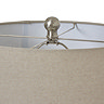 close up image of top of lamp with natural shade and metallic bead detail on the top