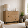 lifestyle image of oak geometric three drawer chest with black handles