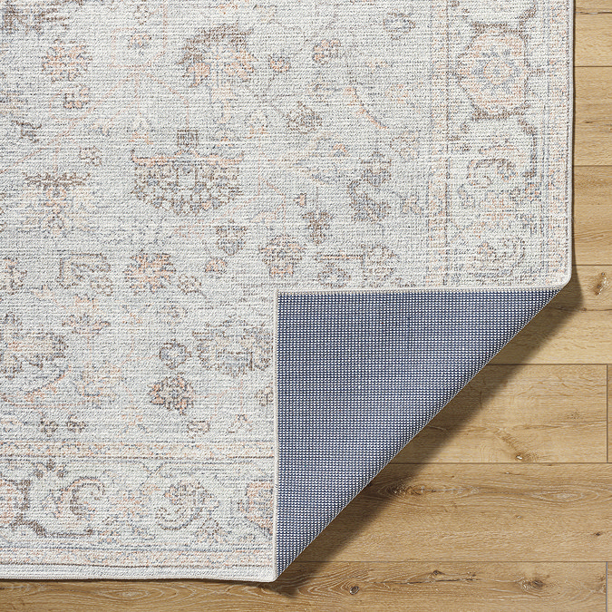 image of corner of traditional rug folded over to reveal material underneath