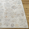 close up image on corner of grey-blue floral vintage rug