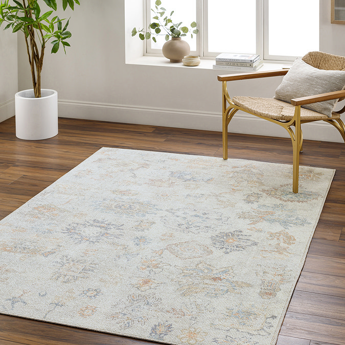 image of light grey-blue floral oriental rug on mid wood flooring of apartment