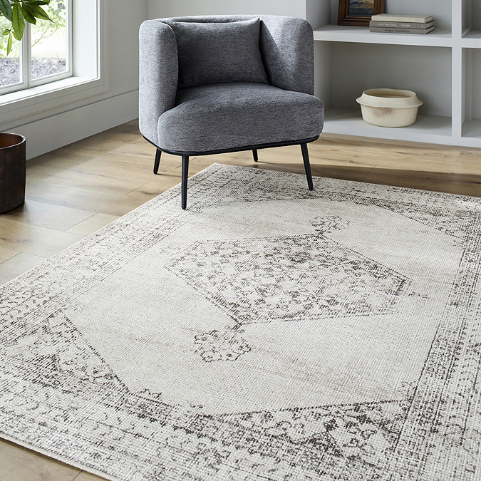 image of brown-grey vintage oriental rug on light wood flooring of apartment