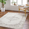 image of vintage oriental cream and brown rug on dark flooring of modern apartment