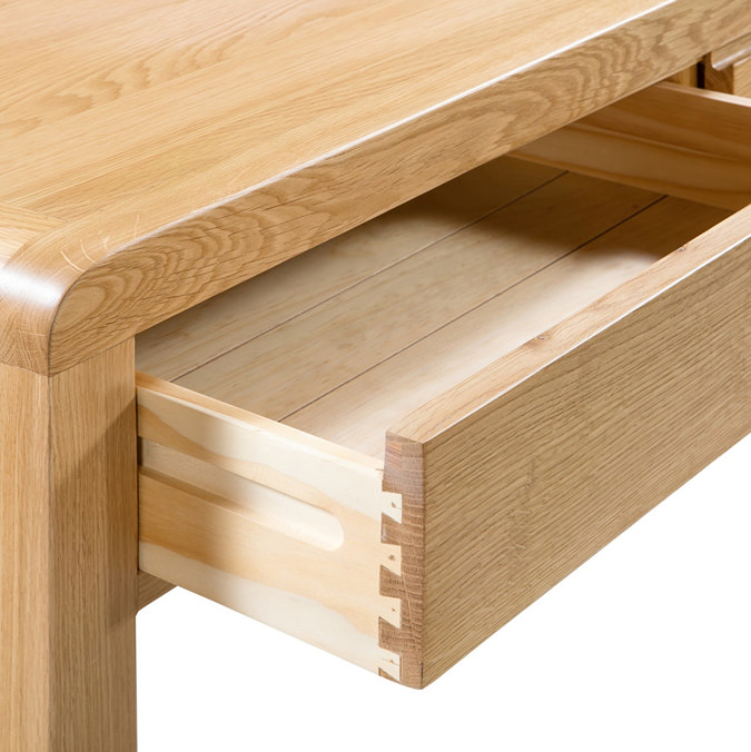 close up image of light wooden desk with drawer open to show trolley open/close function.