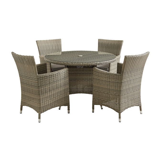image cut out on white background of rattan round dining table with four high backed chairs tucked under