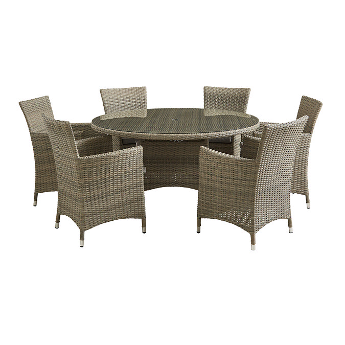 image cut out on white background of rattan dining chairs round matching table with tempered glass top