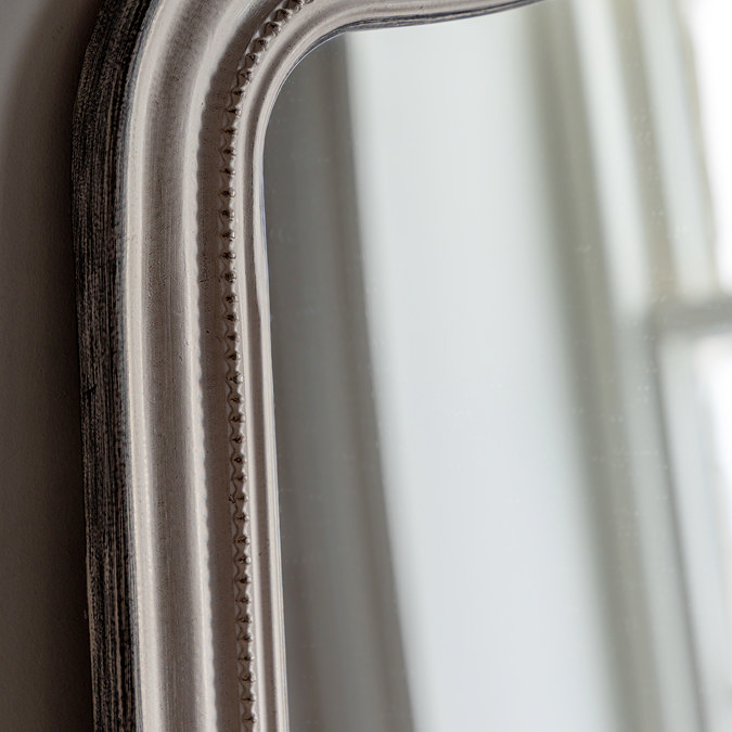 close up image of soft grey frame of decorative overmantle mirror