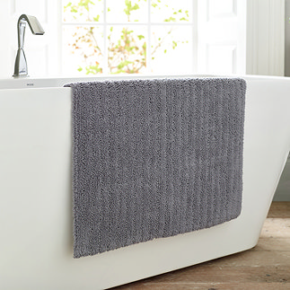 image of charcoal grey bathmat draped over side of bath