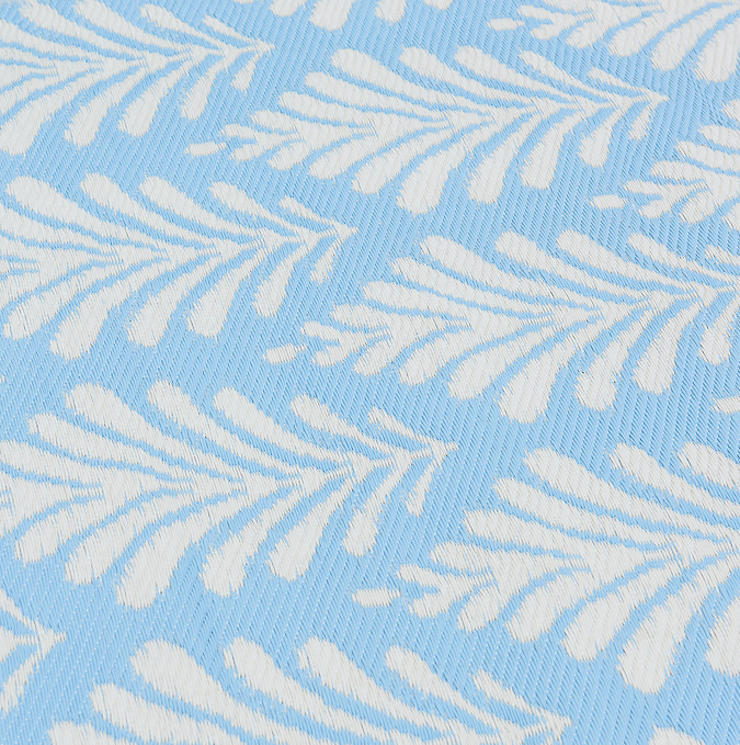close up image of sky blue and white pattern of outdoor rug