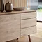 close up on three drawer section of oak wooden sideboard