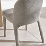 image taken from behind of grey chenille dining chair back with upholstered legs