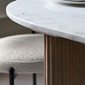 close up image of marble tabletop of mango wood dining table, highlighting unique blue-grey veins and rounded edge