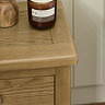 close up image of smooth edges of oak bedside table